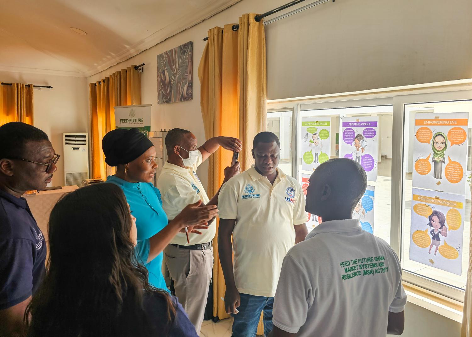 Staff of the Feed the Future Ghana Market Systems and Resilience Activity discuss “caricatures” (like the example on the right) of common behaviors among colleagues and partners that may or may not be conducive to CLA. 